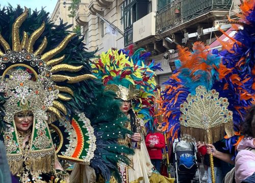 Maltese Carnival parade in Valletta with colourful costumes and masks, showcasing cultural festivals and tourism in Malta